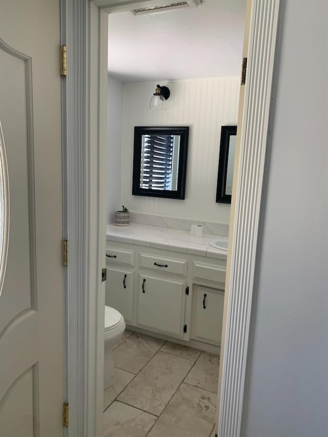 bathroom featuring toilet and vanity