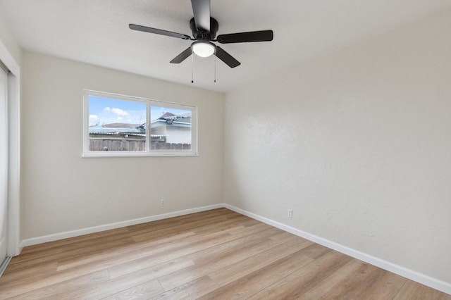 unfurnished room with ceiling fan, baseboards, and light wood-style floors