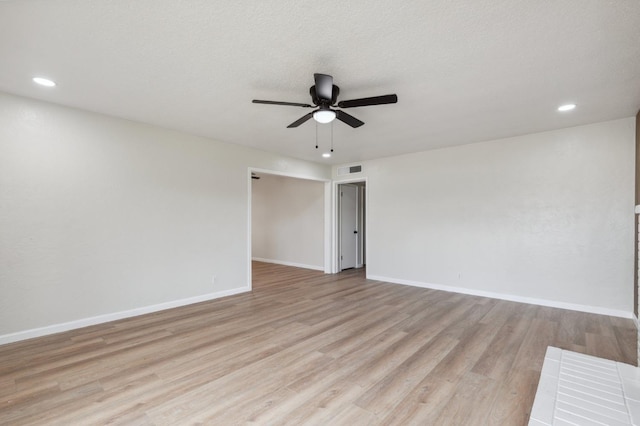 unfurnished room with recessed lighting, light wood-style flooring, a ceiling fan, and baseboards