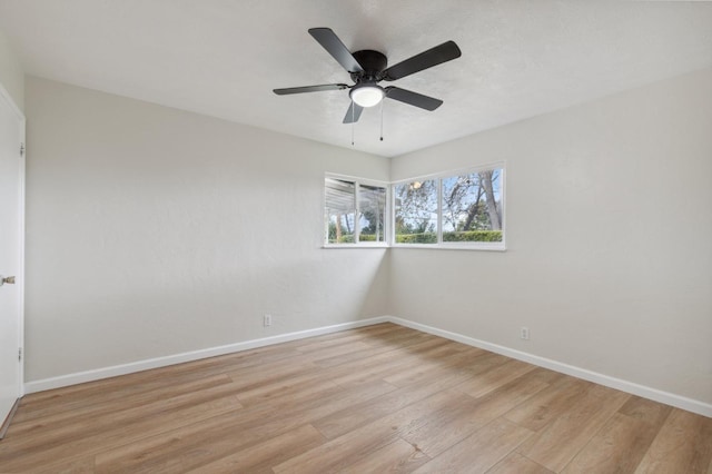 unfurnished room with light wood-style floors, baseboards, and ceiling fan