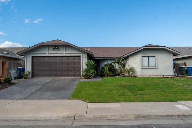 ranch-style house with a garage, fence, a front lawn, and concrete driveway