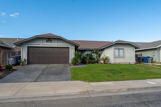 single story home with stucco siding, an attached garage, a front yard, fence, and driveway