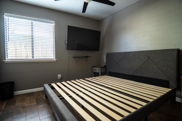 unfurnished bedroom featuring ceiling fan, wood finished floors, and baseboards