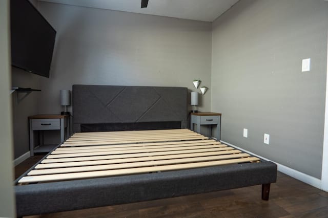 bedroom with wood finished floors and baseboards