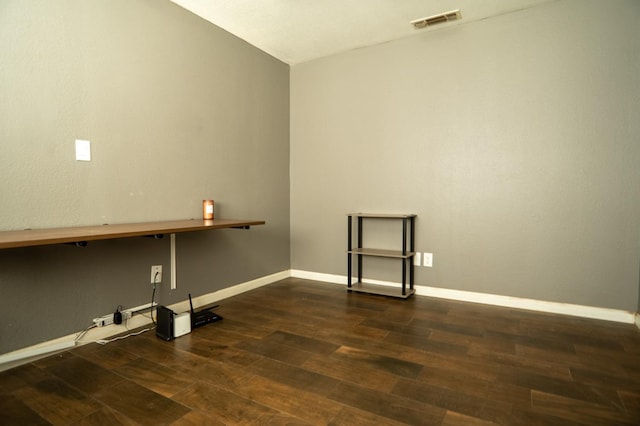 laundry room featuring wood finished floors, visible vents, and baseboards