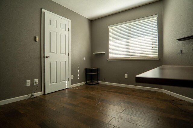 unfurnished room featuring wood finished floors and baseboards