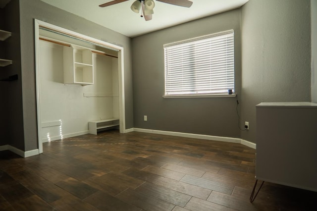 unfurnished bedroom with a closet, wood finished floors, and baseboards