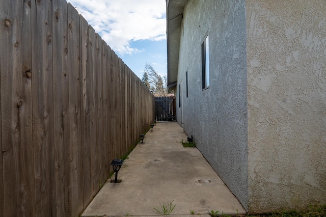 view of home's exterior featuring a patio area, fence, and stucco siding