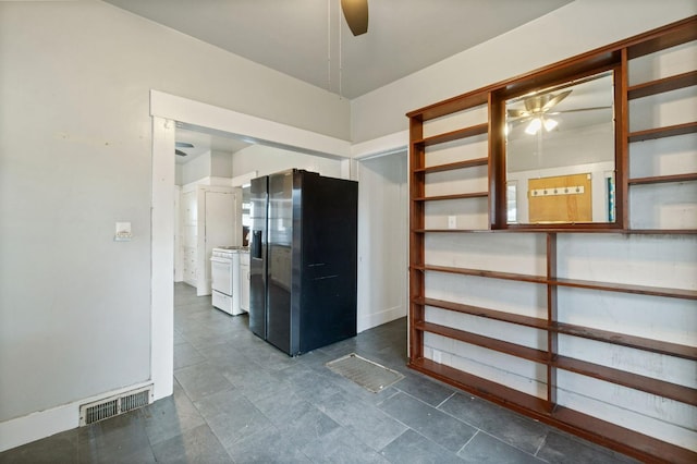 interior space featuring ceiling fan, white gas range oven, stainless steel fridge, and visible vents