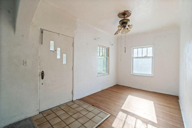 foyer entrance featuring light wood finished floors and ceiling fan