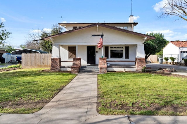 view of front of home featuring a front yard, fence, and brick siding