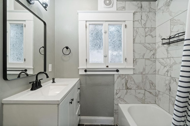 bathroom with visible vents, shower / tub combo with curtain, vanity, and baseboards