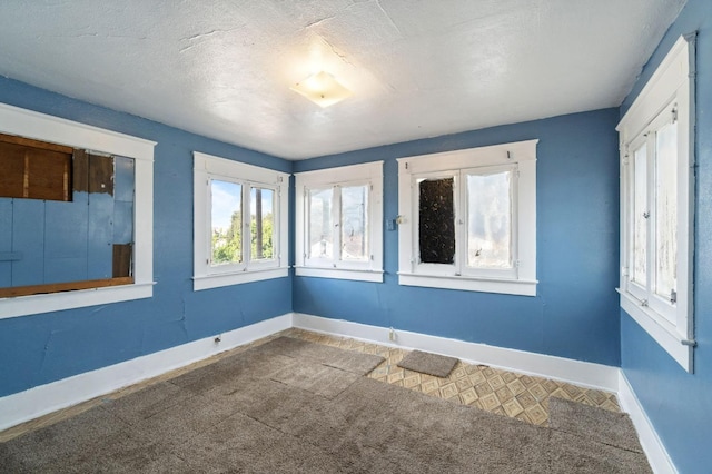 spare room with baseboards