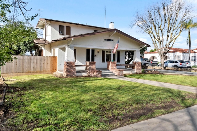 view of front of house with a front lawn, a porch, fence, and stucco siding