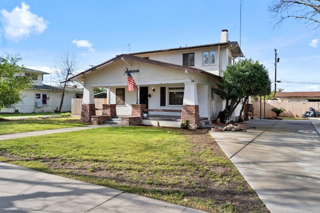 view of front of home with brick siding, fence, stucco siding, a chimney, and a front yard