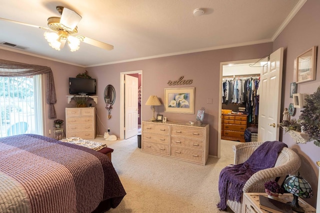 bedroom with light carpet, visible vents, a spacious closet, a closet, and crown molding