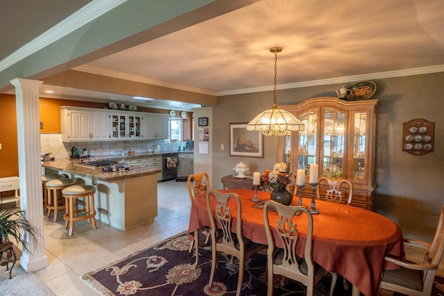 dining room with light tile patterned flooring, crown molding, and ornate columns