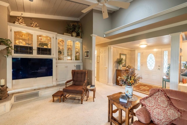 living room with crown molding, decorative columns, visible vents, a ceiling fan, and light carpet