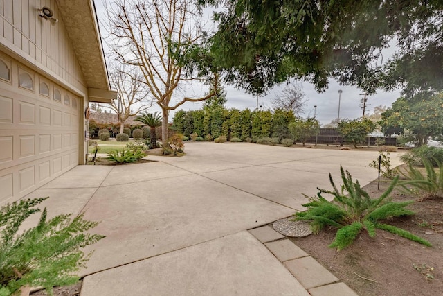 view of patio with driveway and a garage