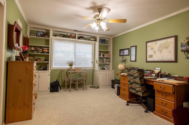 home office with ornamental molding, carpet, visible vents, and ceiling fan