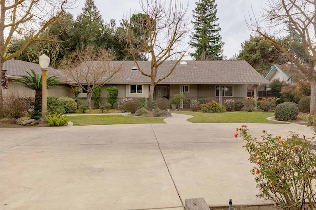 single story home with a front yard and concrete driveway