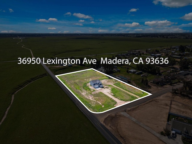 birds eye view of property featuring a rural view