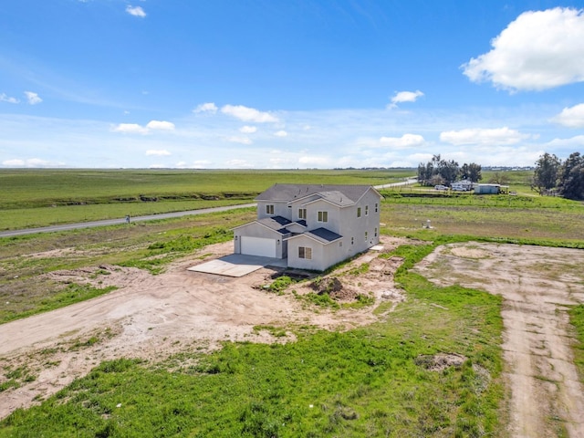 birds eye view of property with a rural view