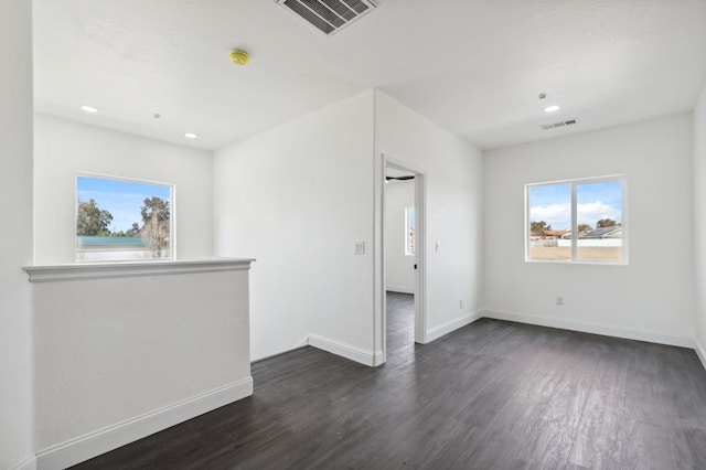 36950 Pauline Ave, Madera, CA 93636 - unfurnished room with visible vents, plenty of natural light, dark wood-type flooring, and baseboards
