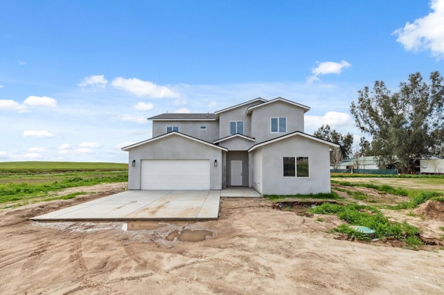 traditional-style home with stucco siding, driveway, and an attached garage