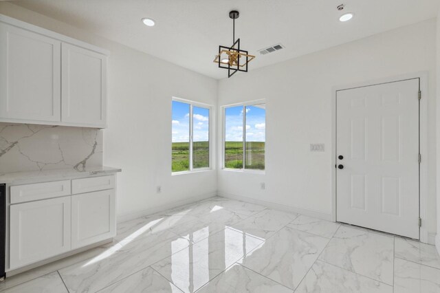36950 Pauline Ave, Madera, CA 93636 - unfurnished dining area with recessed lighting, visible vents, marble finish floor, and baseboards