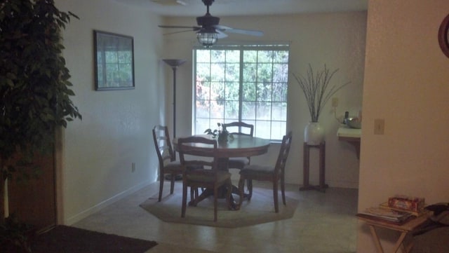 dining room with a healthy amount of sunlight, ceiling fan, and baseboards