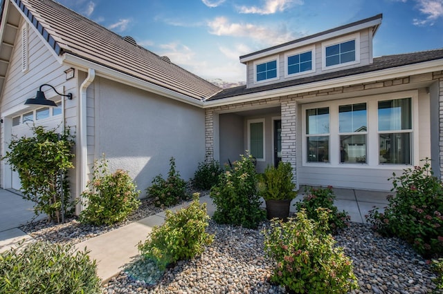 property entrance featuring an attached garage