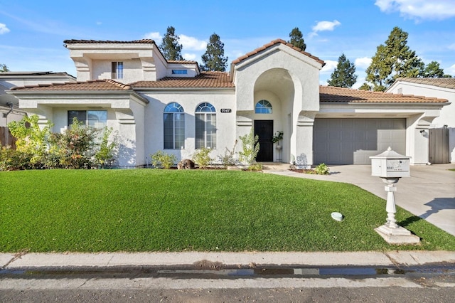 mediterranean / spanish-style home with stucco siding, concrete driveway, an attached garage, a tiled roof, and a front lawn