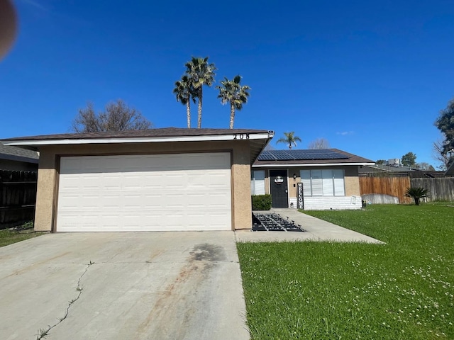 view of front facade with stucco siding, driveway, a front lawn, and solar panels