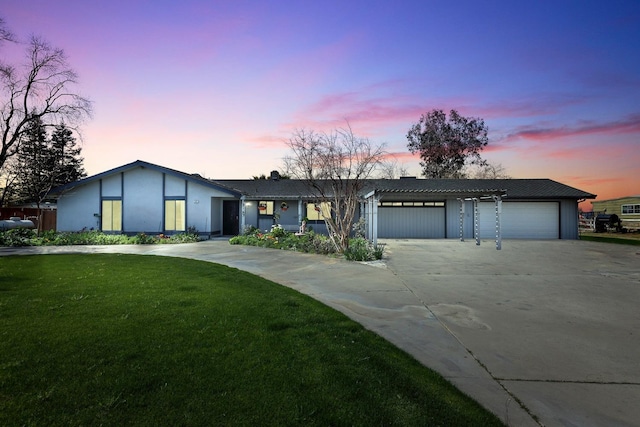 view of front of house with driveway, a garage, and a front yard