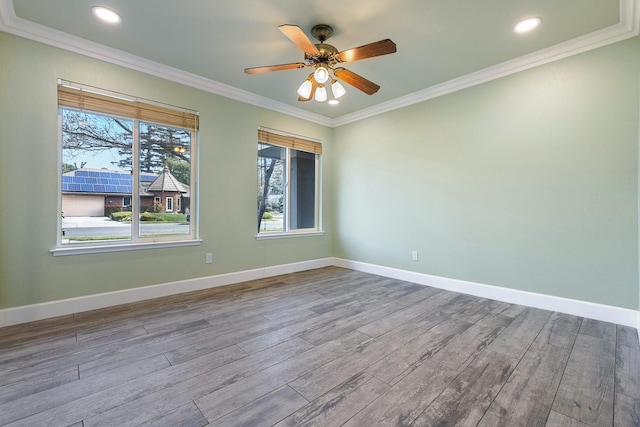 unfurnished room with recessed lighting, ornamental molding, a ceiling fan, wood finished floors, and baseboards