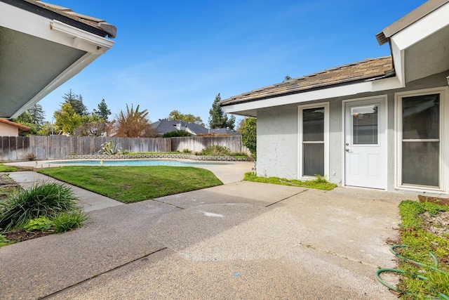 view of yard featuring fence, a fenced in pool, and a patio