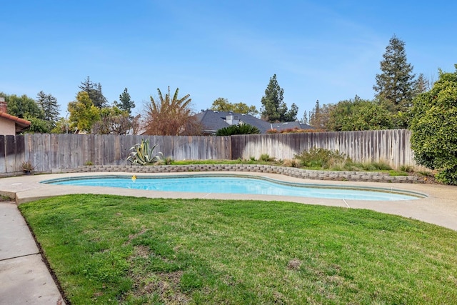 view of swimming pool with a fenced in pool, a fenced backyard, and a yard