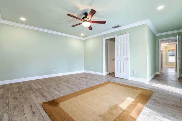 unfurnished bedroom featuring recessed lighting, visible vents, baseboards, light wood finished floors, and crown molding