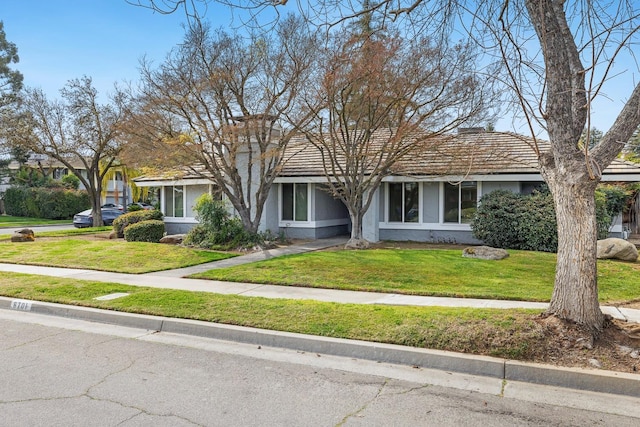 view of front of home with stucco siding and a front yard