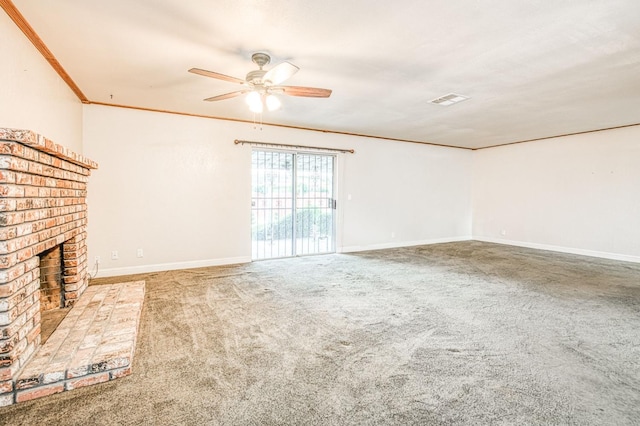 unfurnished living room featuring carpet, crown molding, visible vents, a brick fireplace, and baseboards