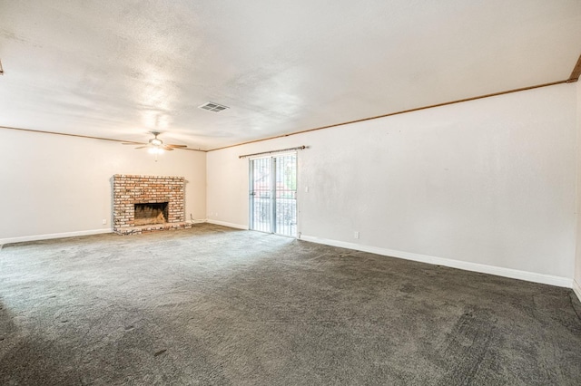 unfurnished living room featuring carpet floors, visible vents, a brick fireplace, ceiling fan, and baseboards