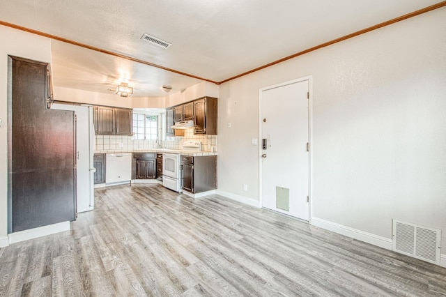 kitchen with light wood finished floors, white appliances, and visible vents