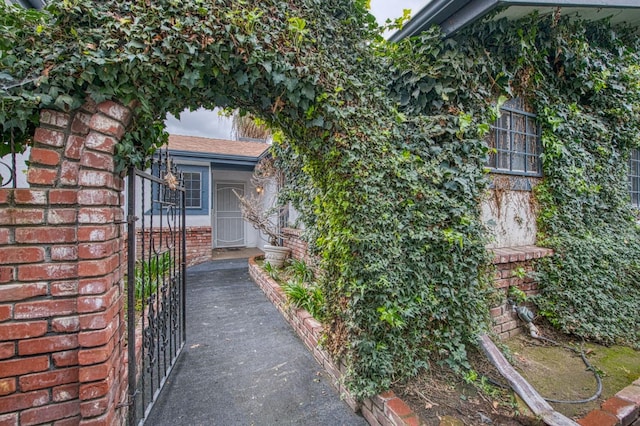 doorway to property featuring brick siding