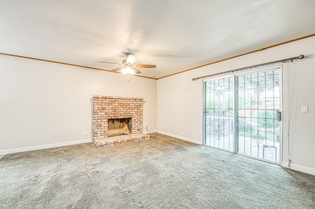 unfurnished living room with a textured ceiling, crown molding, a fireplace, and carpet flooring