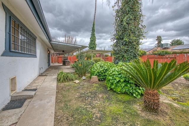 view of yard featuring a patio area, fence, and a pergola