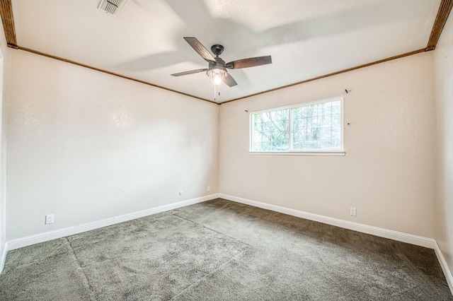 unfurnished room with carpet floors, a ceiling fan, visible vents, and crown molding