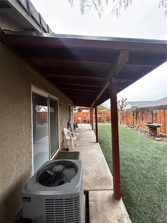 view of patio featuring central AC unit and a fenced backyard