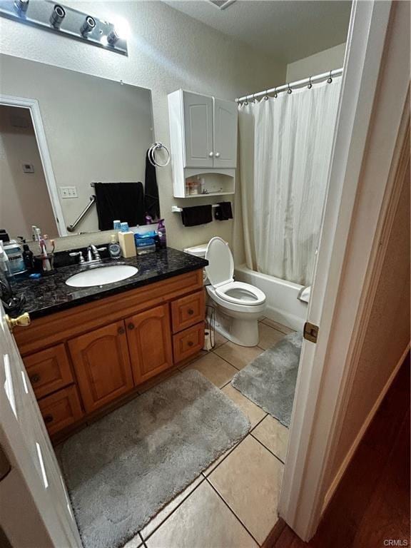 full bathroom with toilet, vanity, shower / bath combo with shower curtain, and tile patterned floors