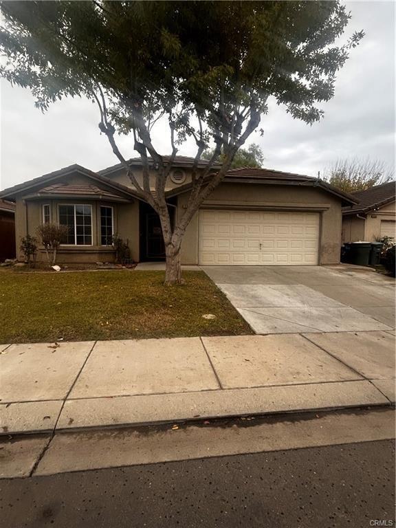 view of front of house with a garage, concrete driveway, and stucco siding